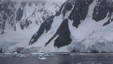 Antarctica-Lemaire-Snow-And-Rocks-Zoom-Out