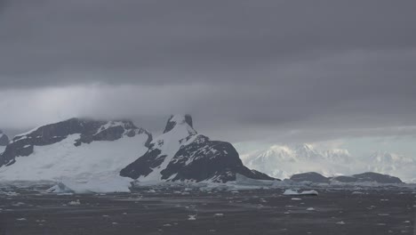 Antarctica-Lemaire-Sun-On-Distant-Mountains