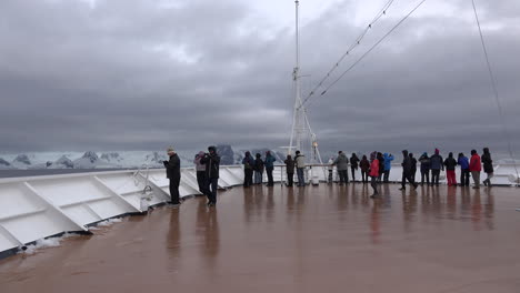 Antarctica-Cruise-Ship-Bow-Man-Takes-Pictures-Then-Walks