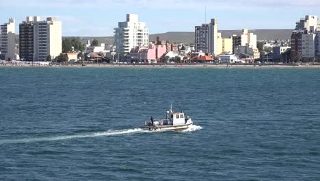 Argentina-Boat-Passes-Puerto-Madryn-Skyline