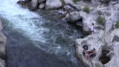 California-Teens-Fishing-By-Holes-In-Rocks