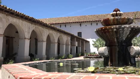 California-Mission-San-Miguel-Arcangel-Colonnade-And-Church-From-Fountain