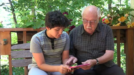 Boy-And-Grandfather-With-Pink-Tablet