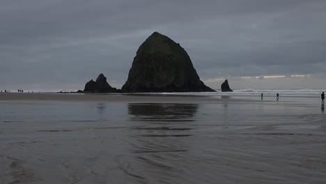 Oregon-Haystack-Rock-With-People-On-Beach