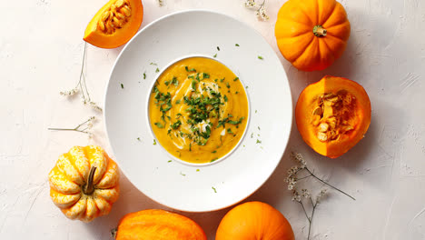 Pumpkin-soup-in-plate-with-vegetables-around