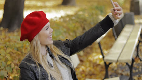 Woman-in-beret-taking-selfie-in-park
