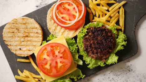 Two-tasty-grilled-home-made-burgers-with-beef--tomato--onion-and-lettuce