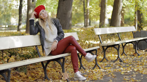 Woman-in-leather-jacket-sitting-on-bench