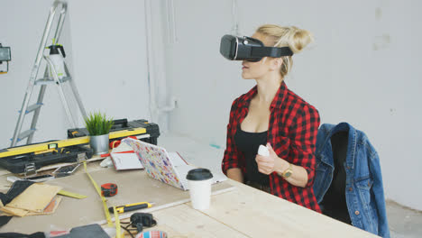 Female-in-virtual-reality-headset-at-laptop-