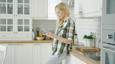 Young-woman-using-phone-at-home