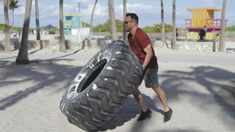 Man-working-out-with-tyre