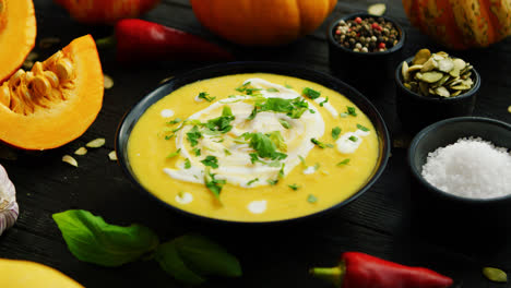 Pumpkin-soup-in-bowl-sprinkled-with-herbs