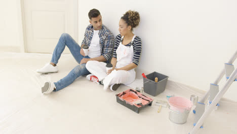 Young-couple-taking-a-break-from-renovating