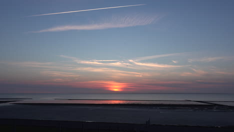 Germany-jet-contrail-and-sunset-on-Wadden-Sea