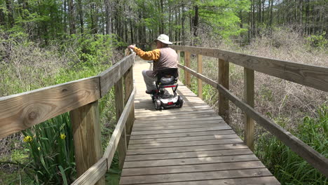 Louisiana-man-on-scooter-looks-over-rail-and-goes-on