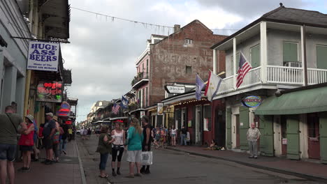 New-Orleans-Bourbon-Street-with-people-and-flag