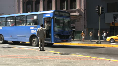 Ecuador-Quito-buses-pass-by