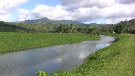 Stream-in-a-valley-with-mountains-in-the-distance