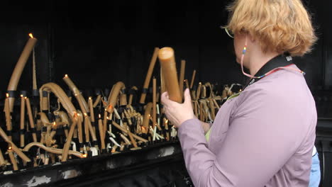 Portugal-Fatima-woman-burns-candles-2