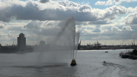 Netherlands-Rotterdam-cranes-behind-spraying-water-from-boat