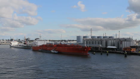 Netherlands-Rotterdam-passing-red-ship-and-refinery-2