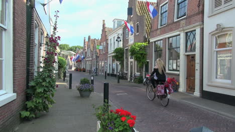 Netherlands-Edam-street-with-bike-red-flowers-and-flags