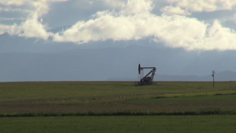 Canada-Alberta-oil-well-with-clouds-s