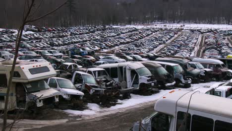 Cars-sit-in-rows-in-a-junkyard-in-the-snow-4