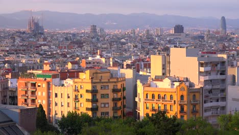 The-distant-skyline-of-Barcelona-Spain-with-Sagrada-Familia-distant-and-apartments-foreground