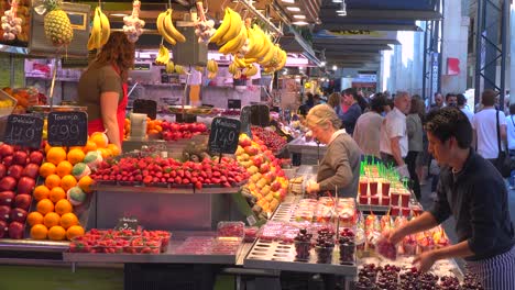 Vendors-sell-their-goods-in-an-indoor-market-in-Barcelona-Spain-1