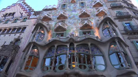 Pedestrians-walk-in-front-of-a-Gaudi-designed-building-in-Barcelona-Spain