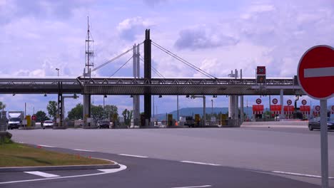 Trucks-and-cars-pass-through-a-tollbooth-on-a-French-motorway