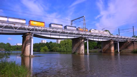 A-freight-train-speeds-across-a-bridge-in-Europe