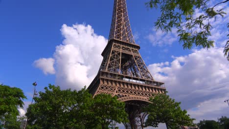Tilt-up-of-the-Eiffel-Tower-in-Paris-with-beautiful-clouds