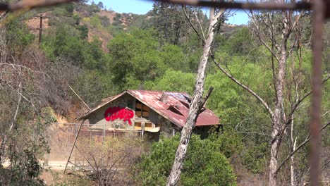 A-rundown-and-scary-cabin-in-the-hills-is-seen-from-a-distance-1