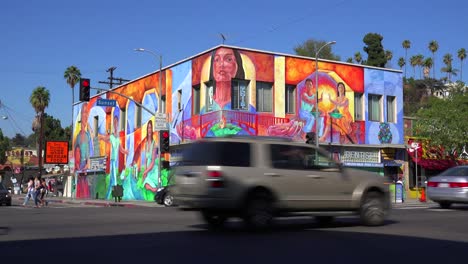 A-building-in-downtown-Los-Angeles-is-brightly-painted-with-murals-and-graffiti