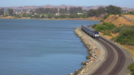 An-Amtrak-train-passes-along-a-shoreline-in-the-Bay-Area-of-California-1