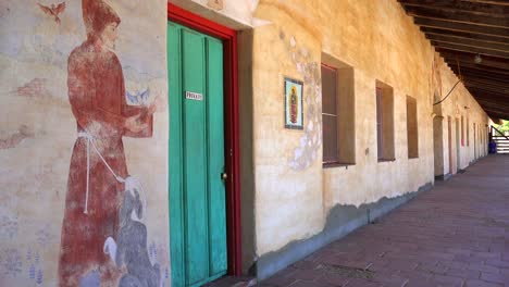 Murals-line-the-adobe-walls-of-a-California-Mission