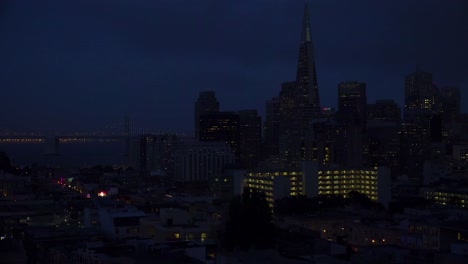Establishing-shot-of-San-Francisco-California-at-night-with-Bay-Bridge-background-1