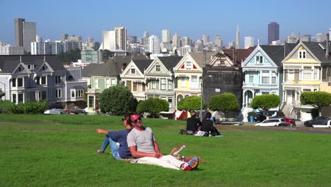 Una-Pareja-Se-Sienta-Espalda-Con-Espalda-En-Un-Parque-Admirando-Las-Casas-Victorianas-De-San-Francisco