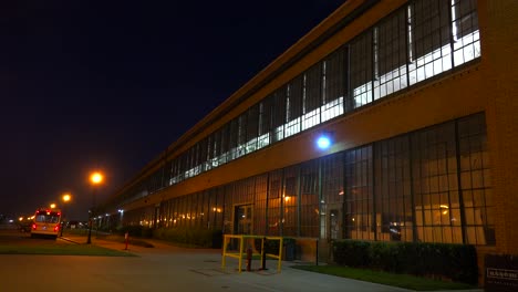 An-establishing-shot-of-a-warehouse-or-factory-at-night-1