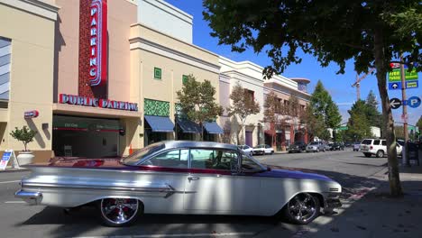 Establishing-shot-of-a-small-retail-business-district-with-a-classic-car-parked-in-front