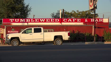The-lonely-Tumbleweed-Cafe-truck-stop-bar-and-cafe-along-a-remote-desert-highway-with-pickup-truck-in-front