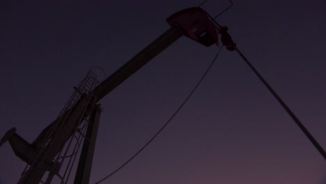 Low-of-an-oil-derrick-pumping-against-the-night-sky-1