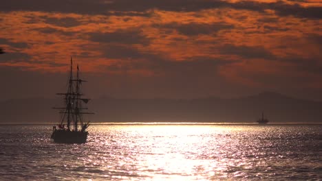 A-tall-clipper-ship-sails-at-sunset