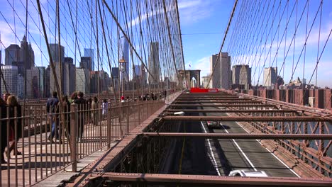 Pedestrians-cross-the-Brooklyn-Bridge-with-Manhattan-and-the-Freedom-Tower-in-the-distance-2