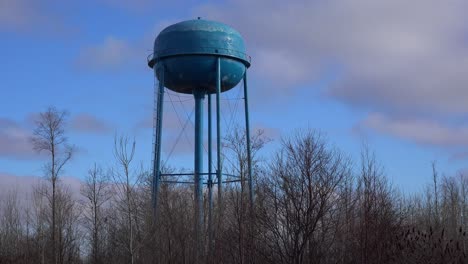 Time-lapse-of-clouds-moving-behind-a-generic-water-tower-in-a-Midwestern-town