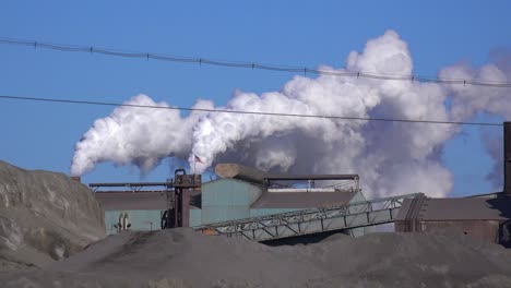 Global-warming-is-suggested-by-shots-of-a-steel-mill-belching-smoke-into-the-air