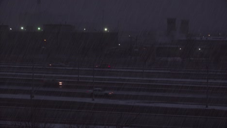 A-snowstorm-hits-near-an-interstate-highway-at-night
