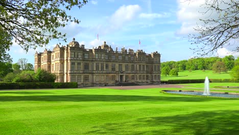 Establishing-shot-of-the-Longleat-mansion-in-England-amidst-green-lawns-and-fountains
